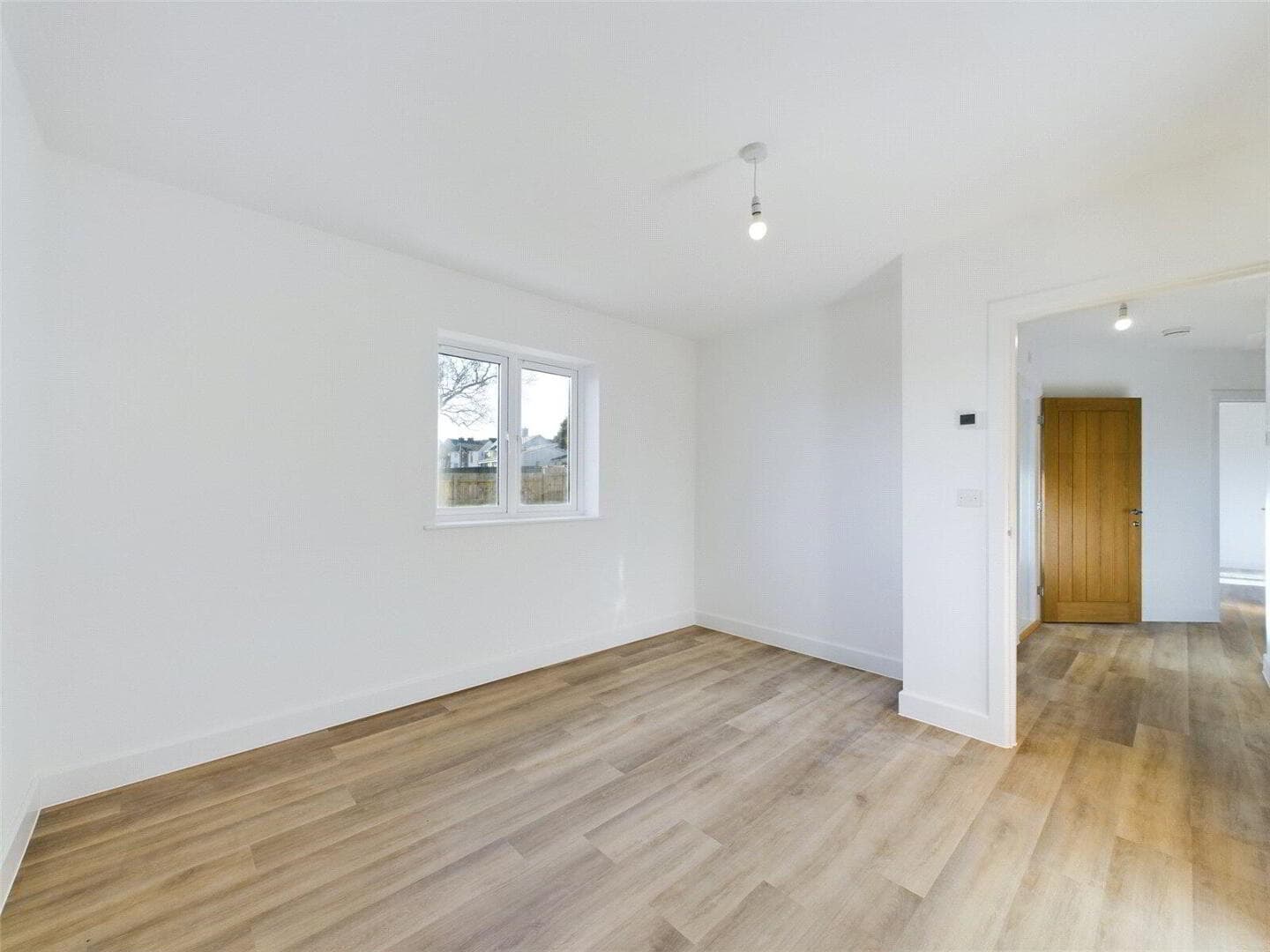 Master bedroom with carpet and pendant lighting
