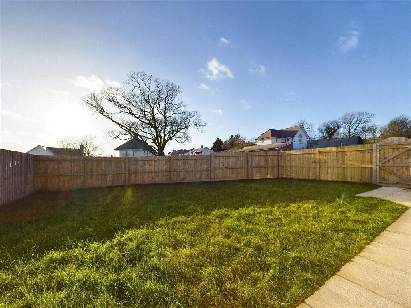 Rear garden showing patio and turfed lawn