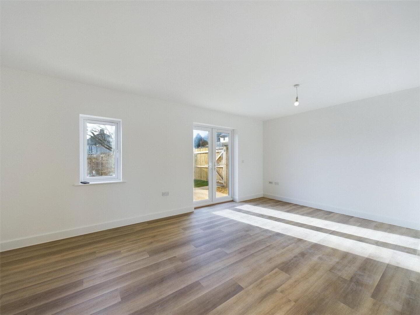 Living area with double patio doors opening to the garden
